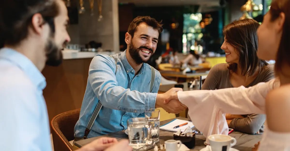 A team enjoying a business dinner before their one-day in-person meeting