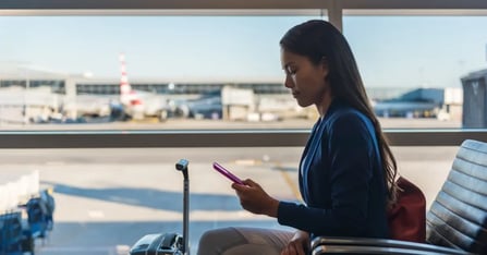 Attendee in an airport lounge while on their phone