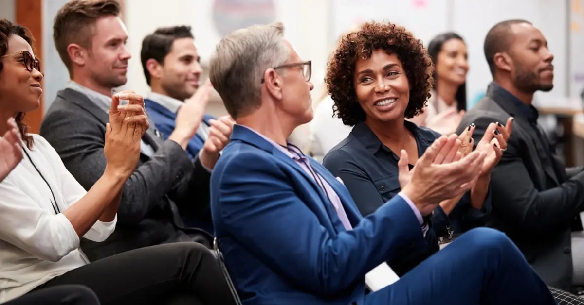 Attendees chatting in the audience at an event