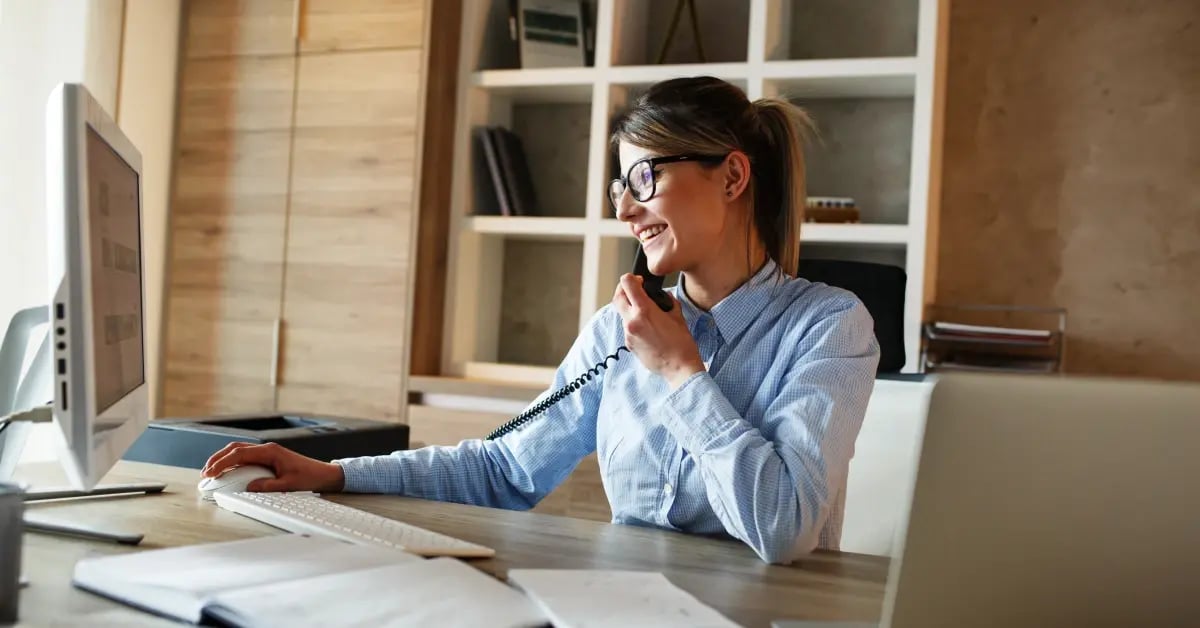 Businesswoman on the phone while working on her laptop