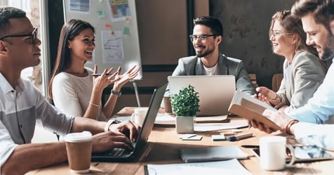 Group of meeting planners in a conference room discussing travel software