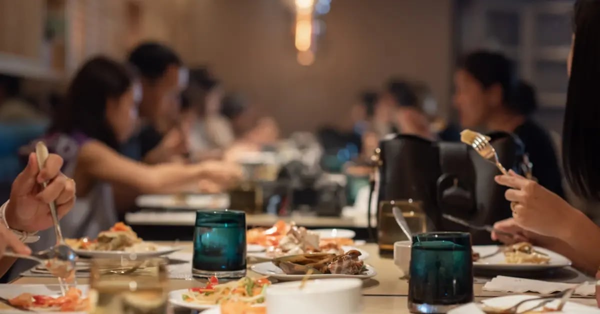 Cropped image of a team eating dinner at a restaurant for a work meeting