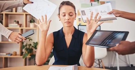 Executive Assistant surrounded by spooky meeting planning myths in the office