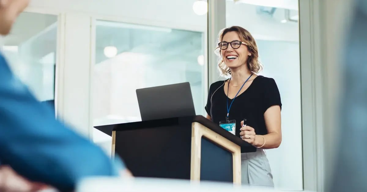 Executive Assistants at the podium of a networking event