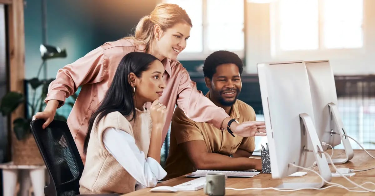 Executive Assistants pulling post-meeting actions on the computer in the office