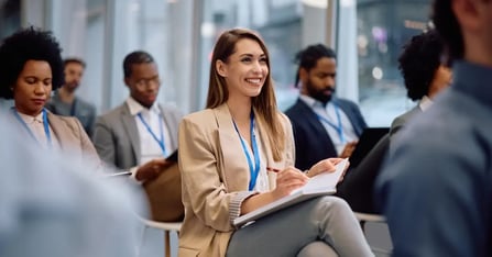 Executive Assistants sitting in seats at a business conference