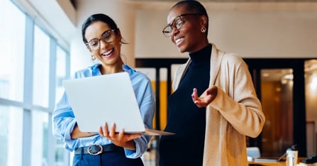 Human Resources and Executive Assistant collaborating on an in-person meeting