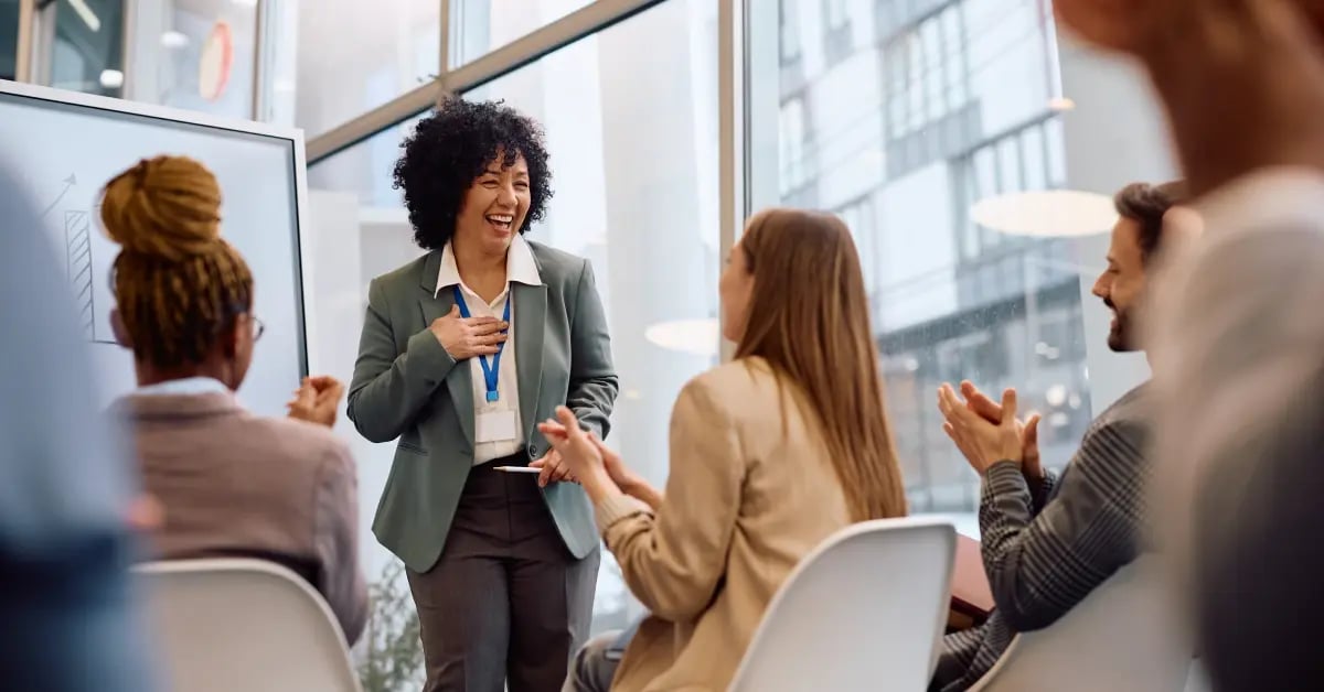 Team celebrating at the end of a session of a in-person meeting