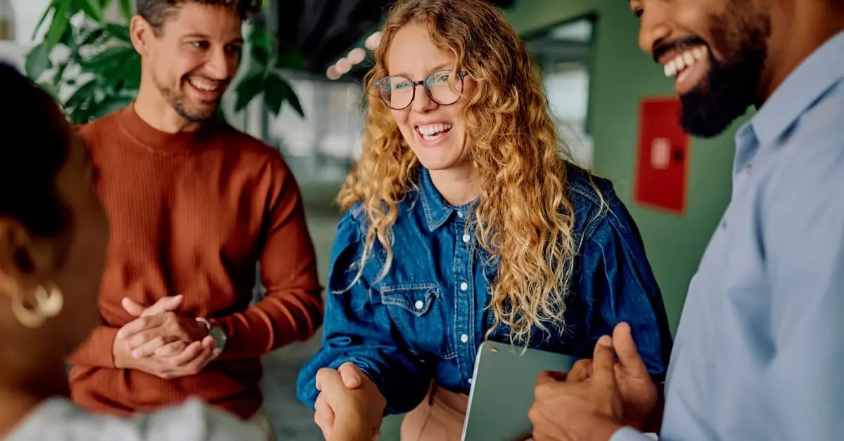 Team connecting in person after a small meeting was planned by an Executive Assistant