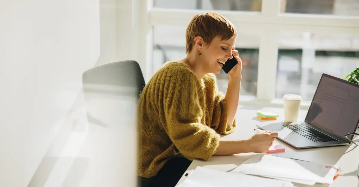 Travel Manager at her desk organizing a travel policy for small meetings